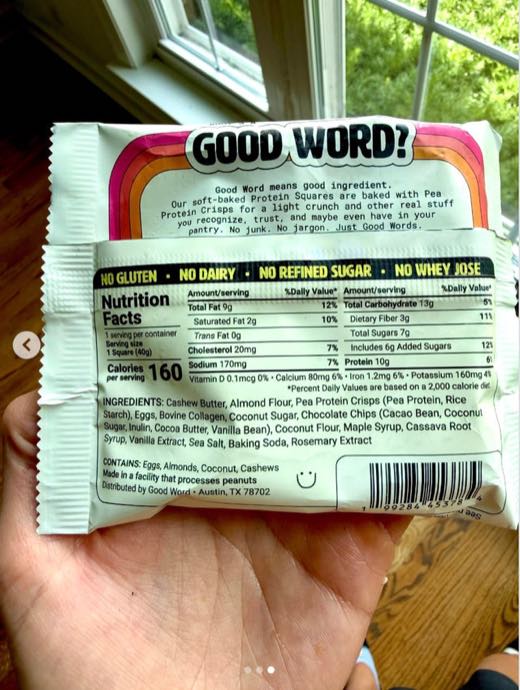 Katie holding the back of a Good Word Protein Square package