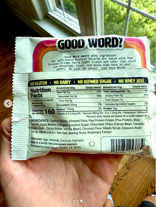 Katie holding the back of a Good Word Protein Square package