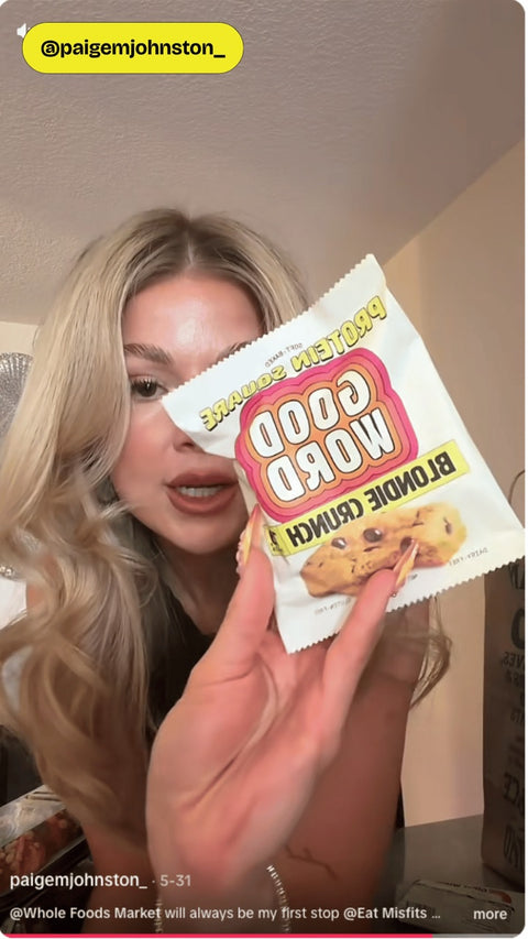 Paige holding a Good Word Blondie Crunch Protein Square