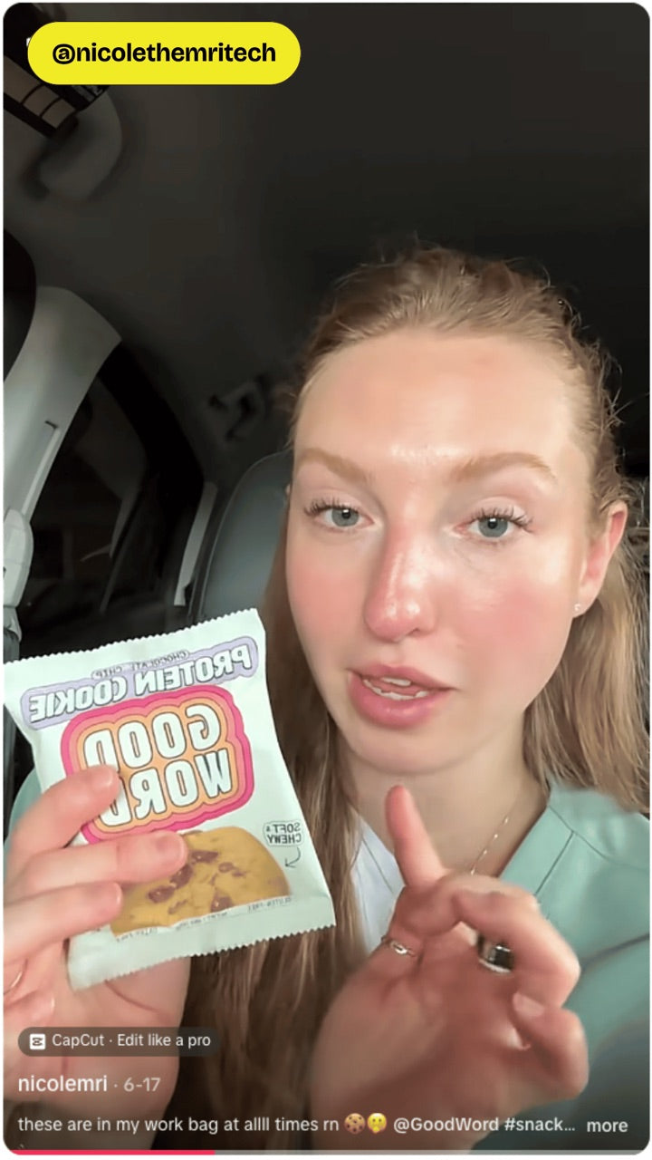 Customer holding a Good Word Chocolate Chip Protein Cookie
