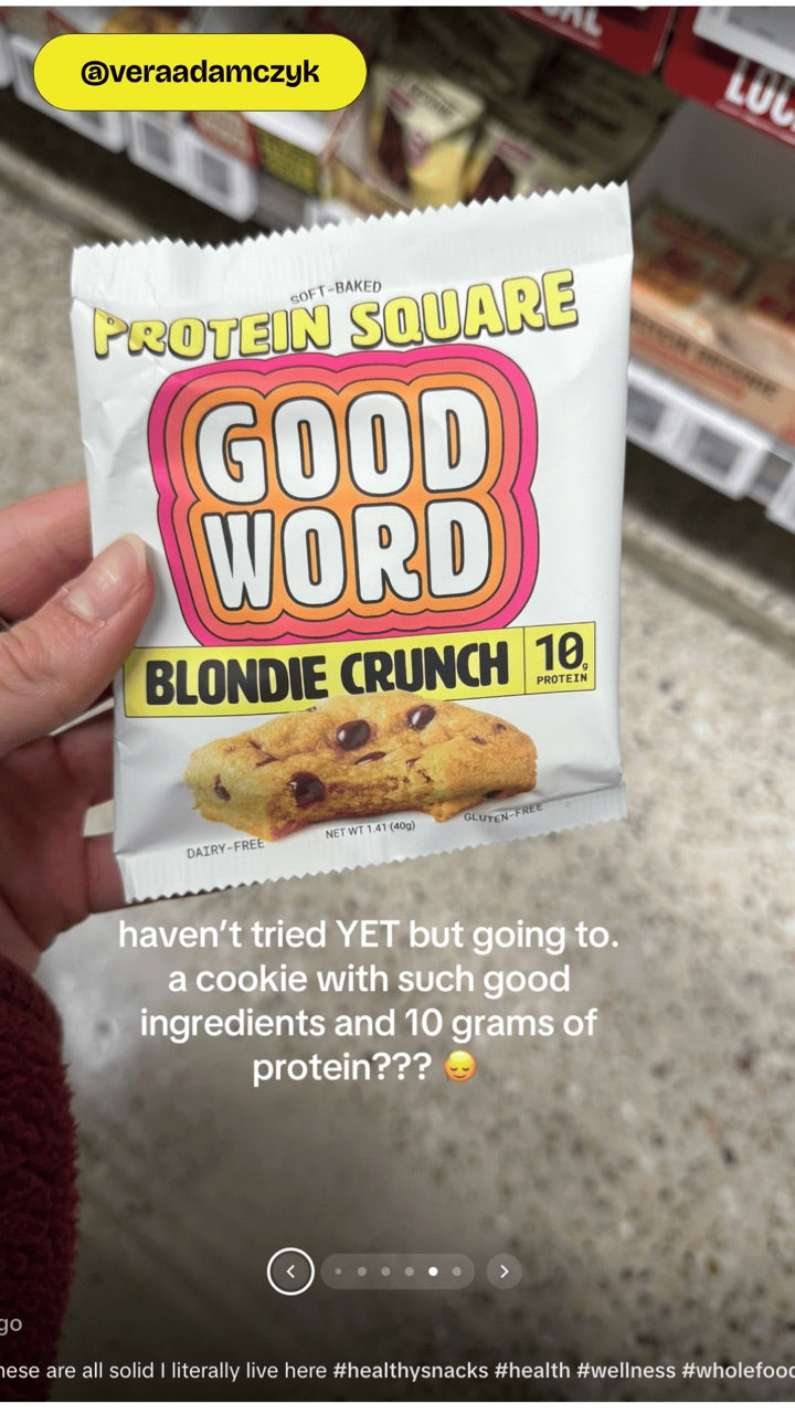 Customer holding a Good Word Blondie Crunch Protein Square at Whole Foods
